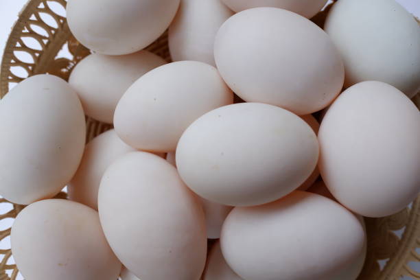 istock Several fresh duck eggs in a plastic basket on a wooden background. Healthy eating concept. Eggs background. 1371645125