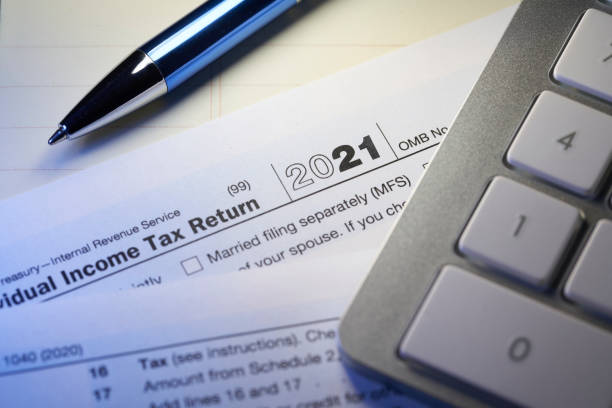 istock 2021 Tax return on desk with pen and calculator 1371651200