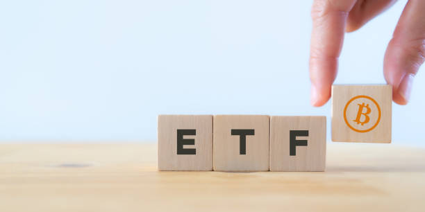 istock Exchange Traded Fund (ETF) and bitcoin cryptocurrency concept.  Entering the digital money fund concept. Investor holds the wooden cube with bitcoin icon standing with 