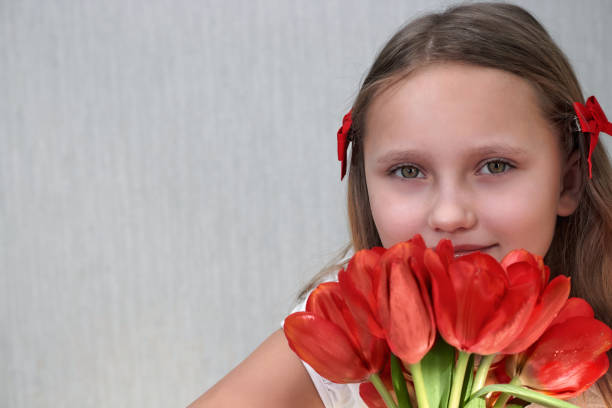 istock Girl with red tulips in bends 1371663242