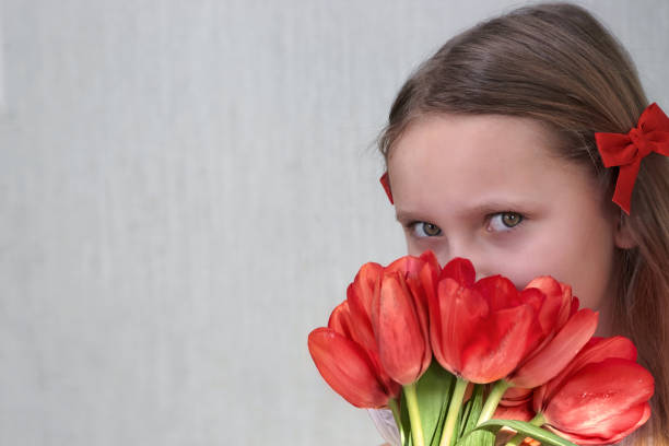 istock Girl with red tulips in bends 1371663247