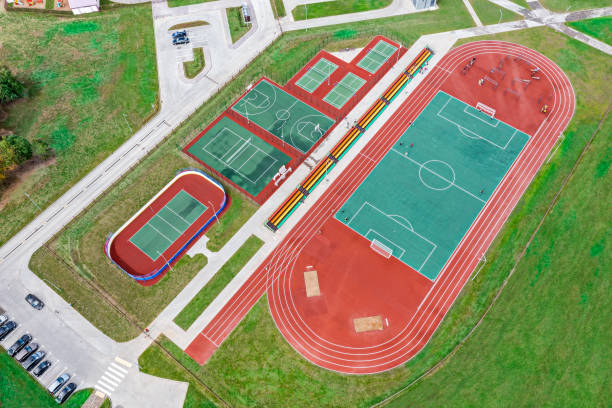 sports grounds for team games of sport, basketball, football, volleyball, handball in a city residential area. aerial overhead view. sports grounds for team games of sport, basketball, football, volleyball, handball in a city residential area. aerial overhead view. recess soccer stock pictures, royalty-free photos & images
