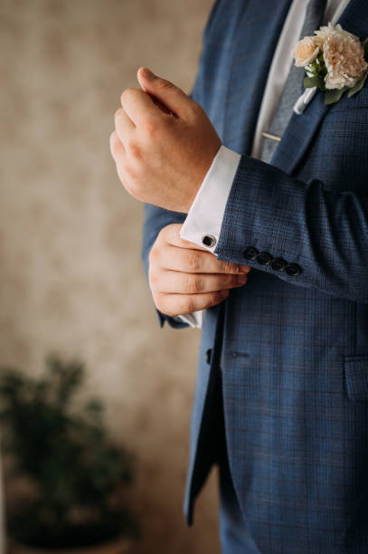 istock Mens hands fasten the cufflink on the jacket 3972. 1371669179