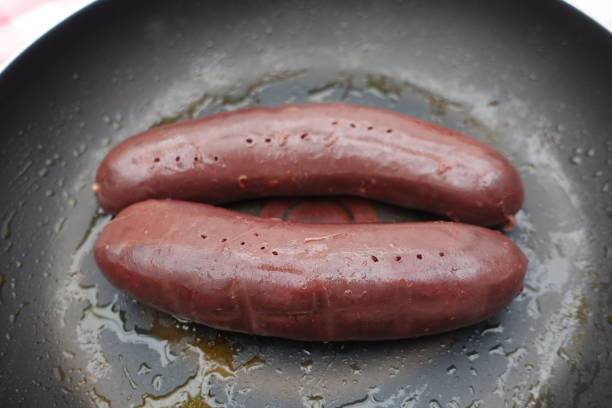 Raw black pudding on a frying pan  French cuisine