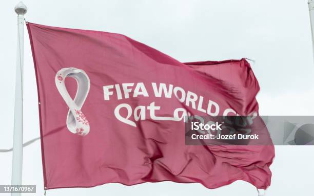 Maroon Fifa World Cup Qatar 2022 Flag Flying In The Sky Above Doha Stock Photo - Download Image Now