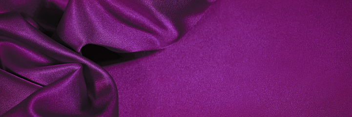 Plum purple silk satin. Soft wavy pleats. Shiny fabric. Luxury background with copy space for design. Web banner. Valentine, anniversary, festive concept.