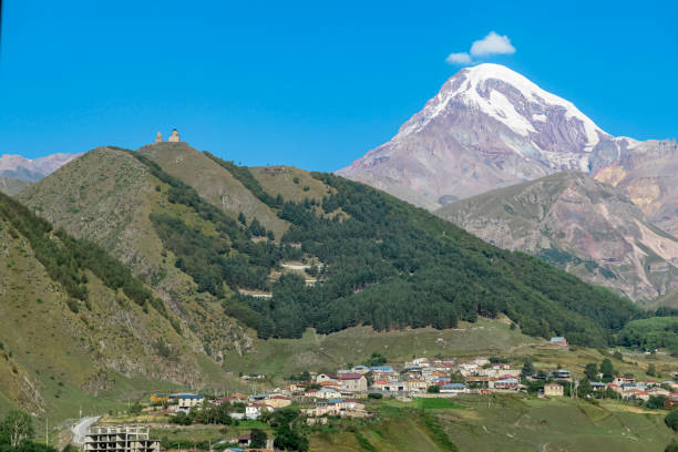 istock Stepantsminda - Distant view on Gergeti Trinity Church in Stepansminda, Georgia. Caucasus 1371677605