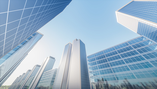 Lookup of skyscraper and cooperate office buildings in downtown Oklahoma City, USA under clear blue sky. Low angle view façade exterior of modern high rise towers