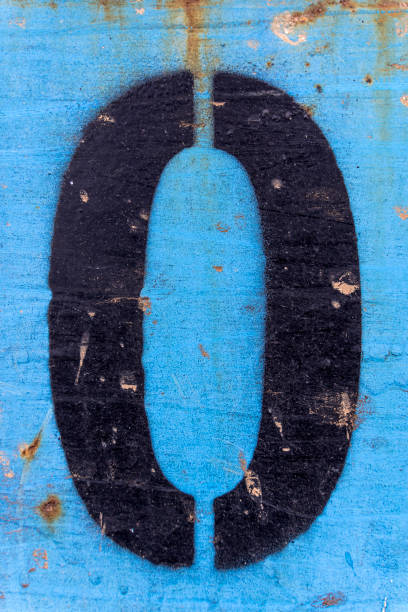 istock Numbers 0 black paint on an old blue iron surface with rust texture and traces of dirt. 1371679543
