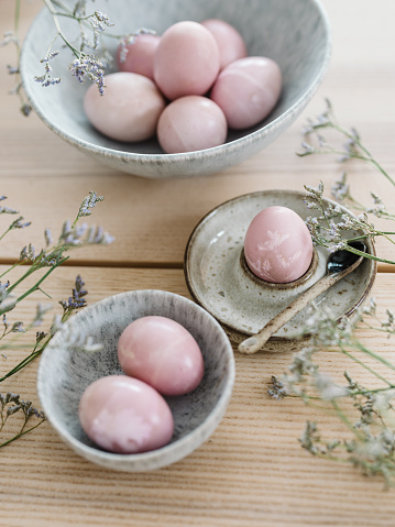 Natural colored easter egg arrangement\nPhoto taken indoors in natural sunlight of eggs colored with beet