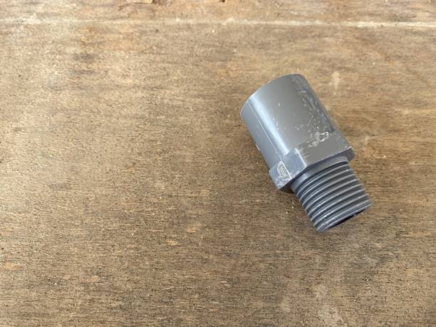 istock PVC pipe connection and pipe clip isolated on wooden background, pipe valve socket 1371689641