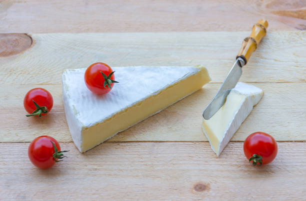 istock Cheese and cherry tomatoes on wooden background. 1371691368