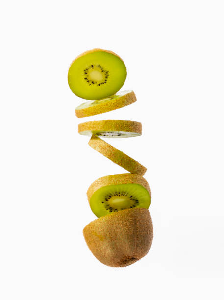 Close up of a sliced kiwi falling