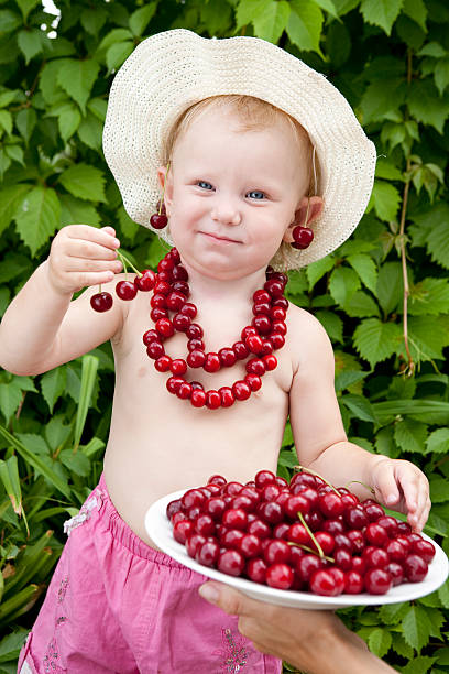 girl with red cherry beads and earrings stock photo