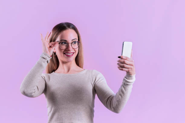 istock Young woman with glasses checking her phone 1371692974