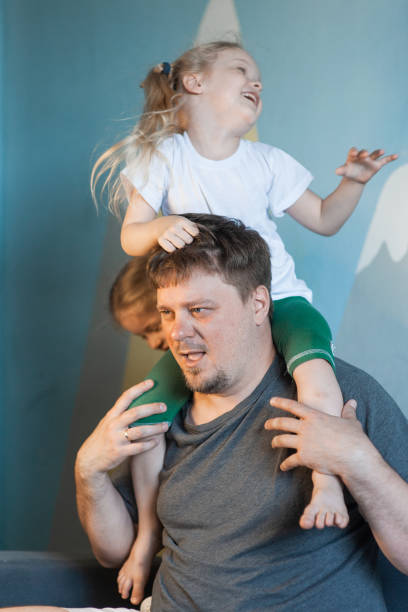 istock dad plays at home with his children: daughters, son 1371693842