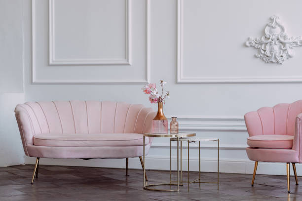 istock Stylish pink armchairs against a white wall with stucco 3648. 1371695707