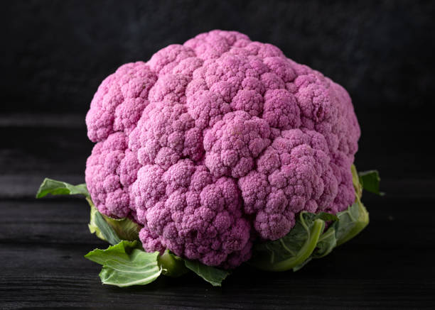 istock Purple colourful cauliflower on black wooden table 1371697061