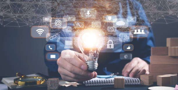 istock Male hand holding light bulb, business and network symbols. Network connection 1371698798
