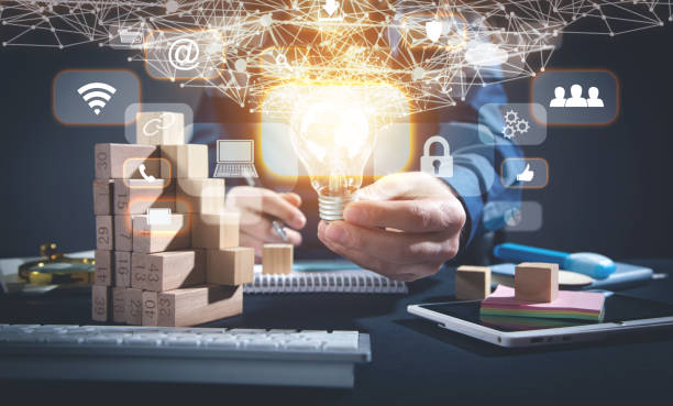 istock Male hand holding light bulb, business and network symbols. Network connection 1371698805