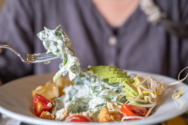 Woman eating salad in a restaurant