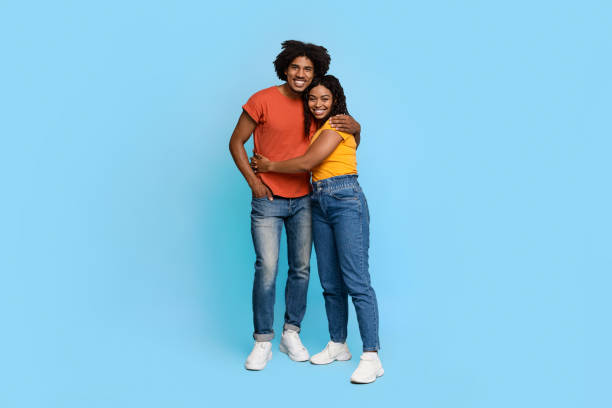 istock Joyful african american couple posing on blue, hugging 1371700456