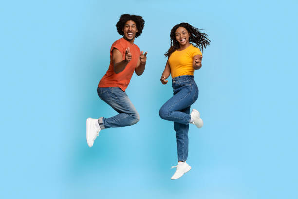 istock Happy african american lovers celebrating success on blue 1371700599
