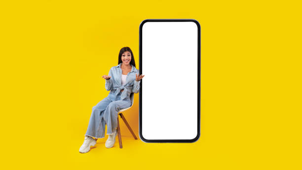 istock Happy lady presenting big white mobile phone screen 1371701291