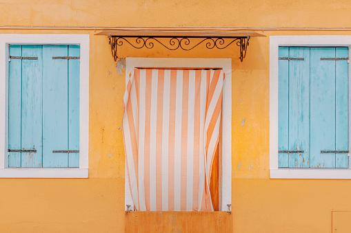 Close-up view of doors and windows of the pastel coloured houses infamous travel destination Burano island, Venezia, Veneto, Italia, Europe