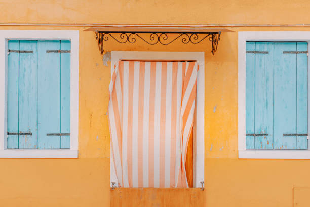 detail view door and windows of the pastel coloured houses in burano, venice, italy - house residential structure multi colored burano imagens e fotografias de stock