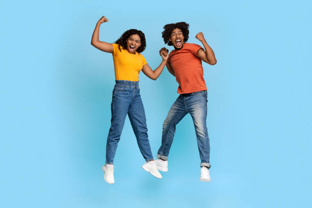 istock Funny african american millennials showing muscles on blue 1371701875