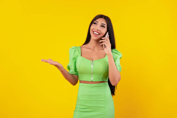 istock Cheerful lady talking on cellphone at yellow studio 1371702087