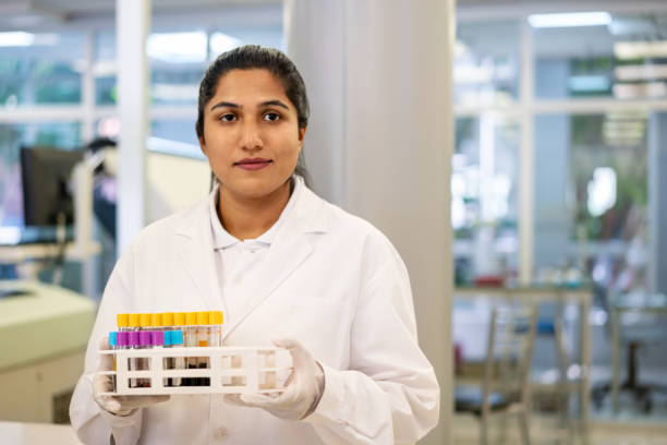 istock Lab technician holding a sample in test tubes at laboratory 1371703788