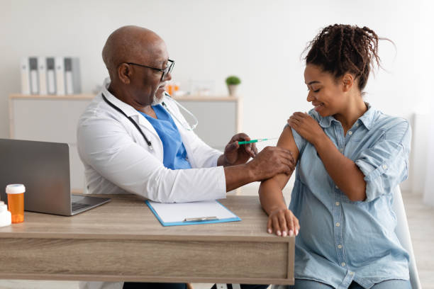 istock Smiling Pregnant Black Woman Getting Vaccinated In Doctor's Office 1371704574