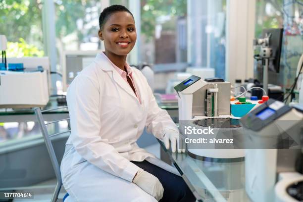 Portrait Of African Female Scientist Working In Laboratory Stock Photo - Download Image Now