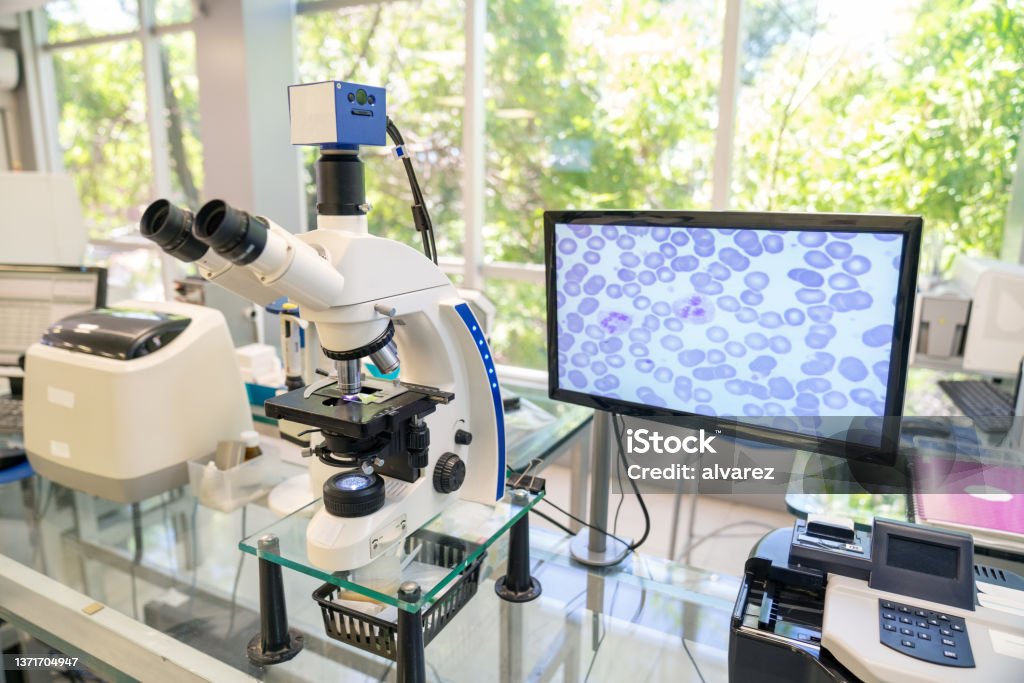 Modern microscope with digital imaging system in the lab Modern microscope equipped with a digital camera, computer and monitor in a biological research laboratory. Modern microscope with digital imaging system Laboratory Stock Photo