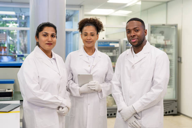 istock Group of scientists working in a laboratory looking at camera 1371705277