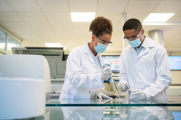 Two scientist conducting an experiment in laboratory