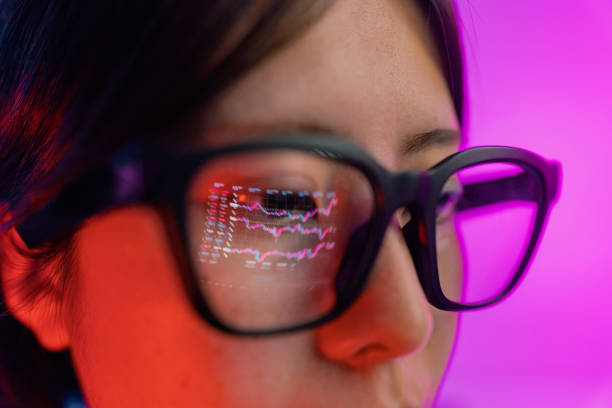 istock Woman checking chart for currency information on laptop. Cryptocurrency chart reflected on smart glasses. 1371709281