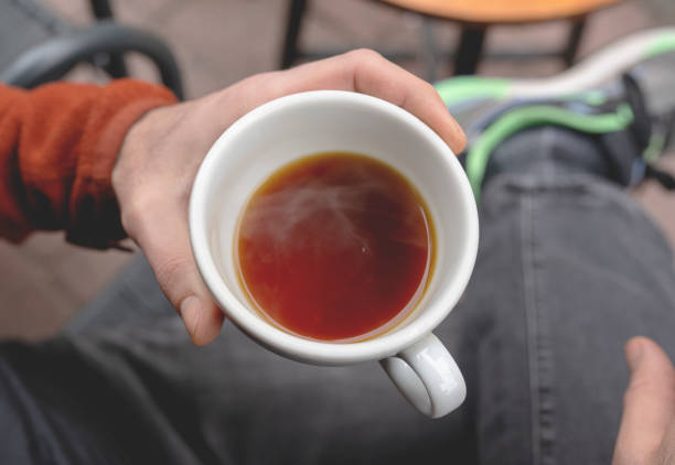 man holding hot coffee mug, lifestyle photos