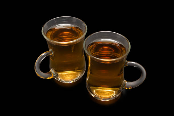 A turkish glass of tea on a black background.