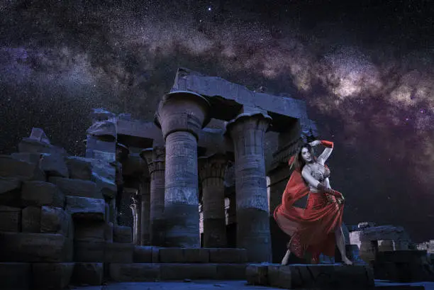 Photo of Oriental dancer under Milky Way at the temple
