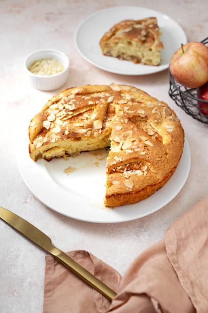 istock Traditional apple pie on a white plate on a light culinary background. Charlotte pie on a platter closeup. Delicious homemade cakes on the kitchen table 1371715707
