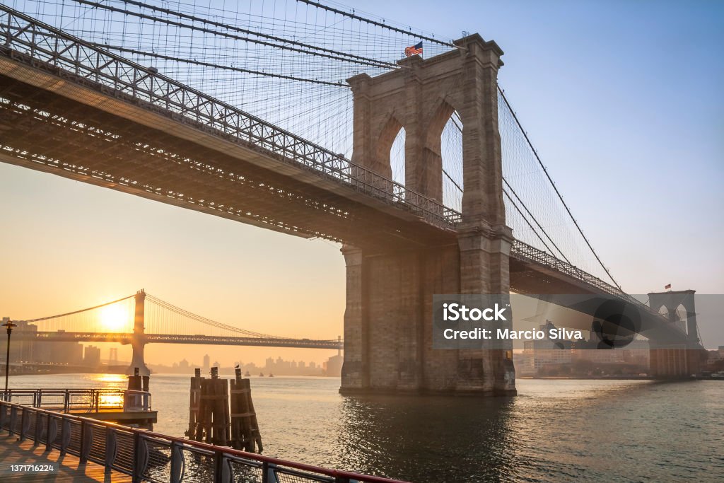 New York View of the iconic architecture of New York city in the USA by the famous Brooklyn Bridge at sunerise. Brooklyn Bridge Stock Photo