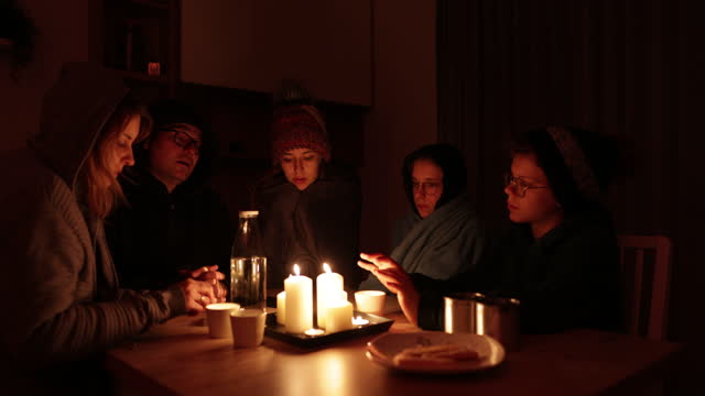 Family sitting by the candles during the blackout.