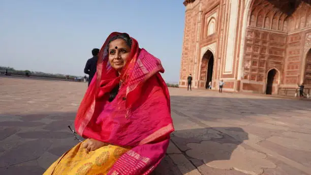 A beautiful Indian woman visiting the Taj Mahal.