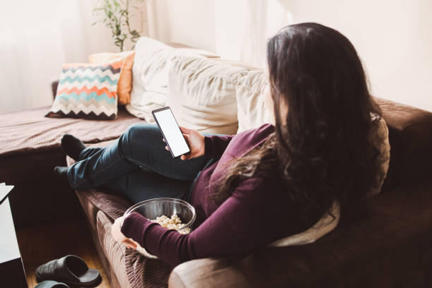 istock A brunette woman using phone at home 1371719156