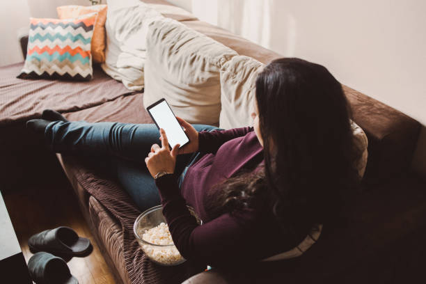 istock A brunette woman using phone at home 1371719312