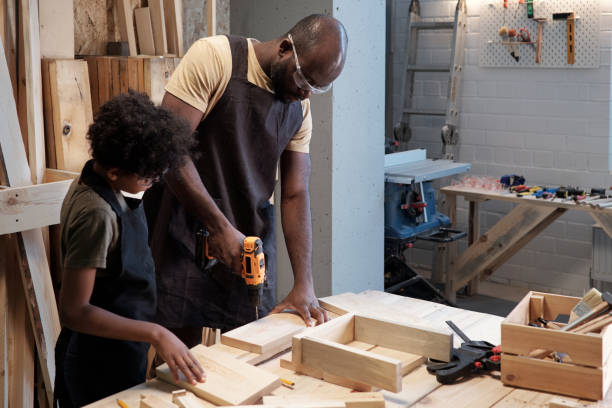 istock Father and Son Together in Workshop 1371721593