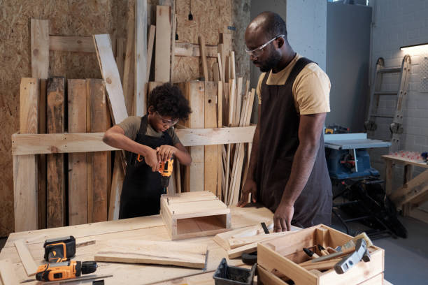 istock Father and Son Building Birdhouse in Workshop 1371721608